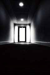 Haunted corridor leading to the light behind the door