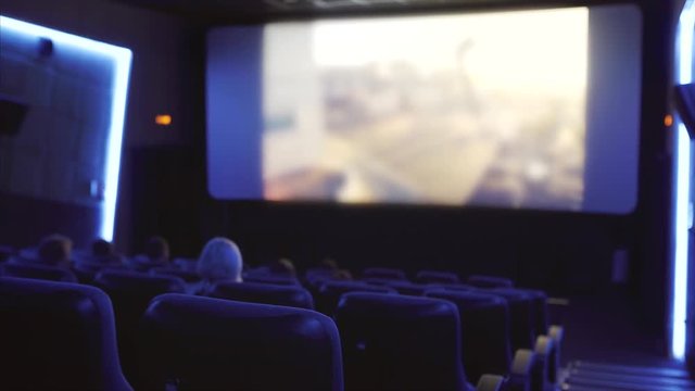 cinema hall with viewers and unidentified film on the screen