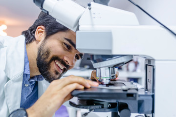 Young Student Researcher Man Work with Lab Microscope.