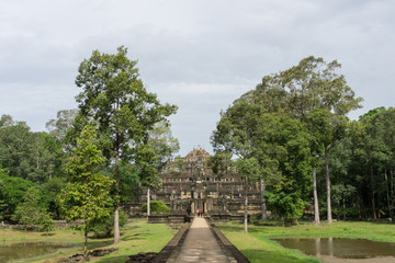 Fototapeta na wymiar The long stone walkway to the Baphuon Temple inside the Angkor Thom complex near Siem Reap, Cambodia