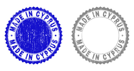 Obraz premium Grunge MADE IN CYPRUS stamp seals isolated on a white background. Rosette seals with grunge texture in blue and grey colors. Vector rubber watermark of MADE IN CYPRUS title inside round rosette.