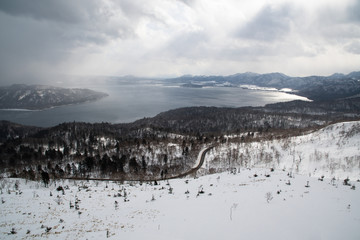 冬の地吹雪の美幌峠から見た冬の屈斜路湖　（北海道・弟子屈町）