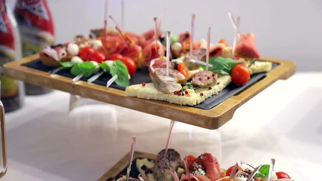 Buffet table. Sandwiches with sausage, tomato and mozzarella. Delicious snacks on the Banquet table