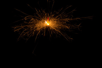 Fototapeta premium Bengal fire. New year sparkler candle on black background