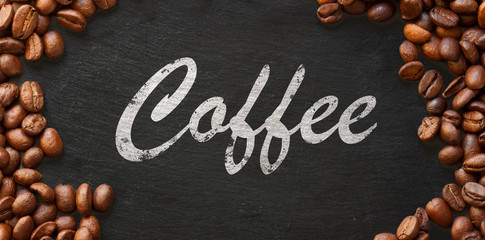 coffee handwritten on dark background framed with coffee beans