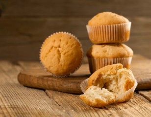 Vanilla cupcake, homemade cakes on wooden background