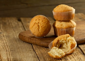 Vanilla cupcake, homemade cakes on wooden background