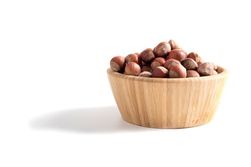Wooden Cup with hazelnuts isolated on white background