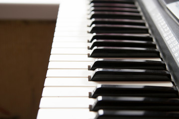 Fototapeta premium Close-up piano keyboard with blurred background