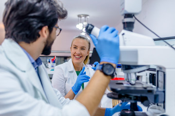 Young students of chemistry working in laboratory