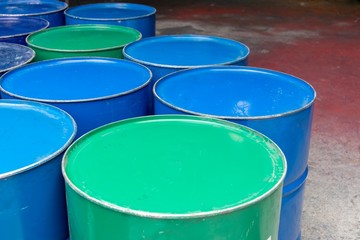 Recycled metal barrels painted in green and blue