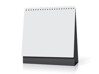 white paper calendar stands on the table