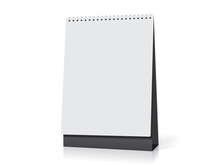 white paper calendar stands on the table