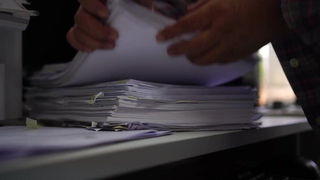Businessman hands checking documents file paperwork financial market, searching information on work busy desk office. Piles of document achieves with pen for sigh. Business report  concept
