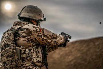 German Schützenschnur | Dramatic view of a German military soldier firing the P8.