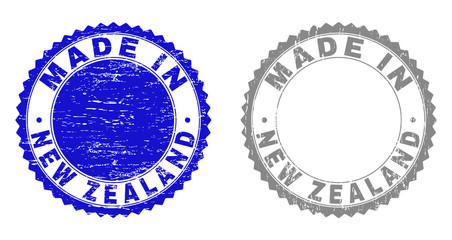 Grunge MADE IN NEW ZEALAND stamp seals isolated on a white background. Rosette seals with distress texture in blue and grey colors.