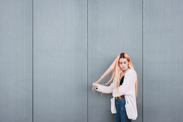 girl young hipster millennial with hair color against gray wall with space for text