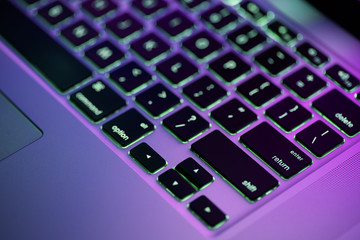 Keyboard laptop. Backlit computer keyboard closeup. Hi tech concept
