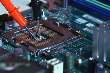 Close up needle tipped tip multimeter checking service  repairing cpu computer. Repairing and...