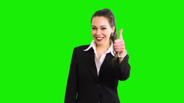 Beautiful young businesswoman portrait thumbs up isolated on green screen chroma key