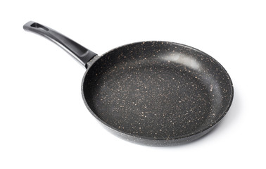 New black pan on a white background. Dishes.