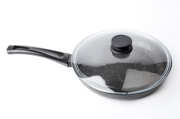 New black pan on a white background. Dishes.