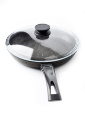New black pan on a white background. Dishes.