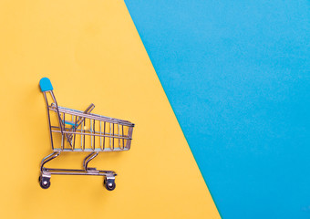 Collection of shopping cart  full of shopping time.Top view or flat lay composition cart on color...