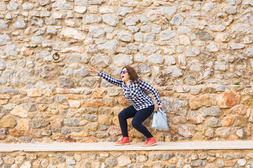 Emotions and gestures - Surprised young woman pointing something outdoors