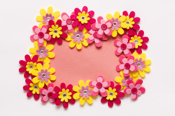 Happy Mother's Day, Women's Day, Valentine's Day or Birthday Living Coral Pantone Color Background. Coral flat lay greeting card template with beautiful fake flowers.