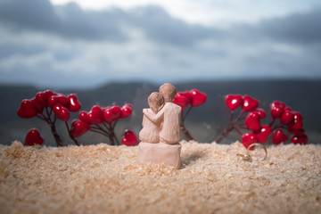 Valentines Day love concept. Figurine of married couple hugging , couple in love and pre-wedding background concept.