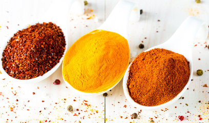 Spices in Wooden spoon. Herbs. Curry, Saffron, turmeric, rosemary, cinnamon, garlic, pepper, anise on wooden rustic background. Collection of spices and herbs. Salt, paprika. Copy space. Top view. Ban
