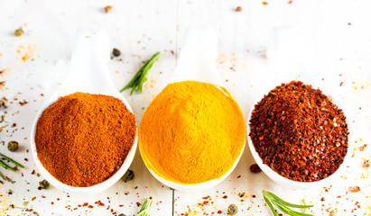 Spices in Wooden spoon. Herbs. Curry, Saffron, turmeric, rosemary, cinnamon, garlic, pepper, anise on wooden rustic background. Collection of spices and herbs. Salt, paprika. Copy space. Top view. Ban