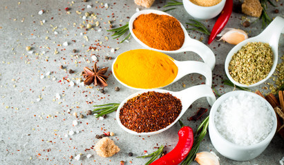 Spices in Wooden spoon. Herbs. Curry, Saffron, turmeric, rosemary, cinnamon, garlic, pepper, anise on wooden rustic background. Collection of spices and herbs. Salt, paprika. Copy space. Top view. Ban