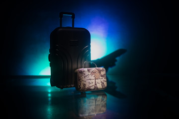 stack of traveling luggage in airport terminal and passenger plane flying over sky