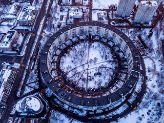 Aerial view of a 9-storey residential building in the form of a ring built in the late 1970s. Moscow, winter.