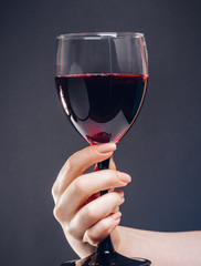 glass of red wine in a woman's hand