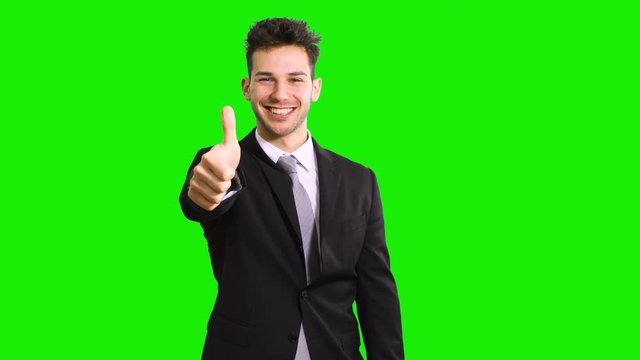 Businessman giving thumbs up isolated on green screen chroma key