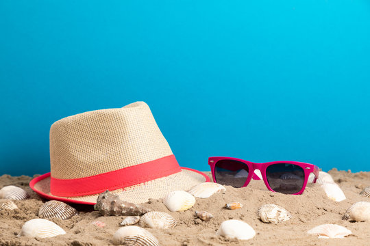 strand hat, sunglasses and shell for holiday