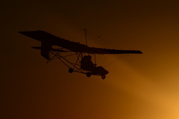 Ultralight airplane at sunset.