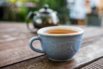 Cup with tea blue wooden table nature light taste aroma teapot transparent