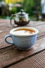 Cup with tea blue wooden table nature light taste aroma teapot transparent