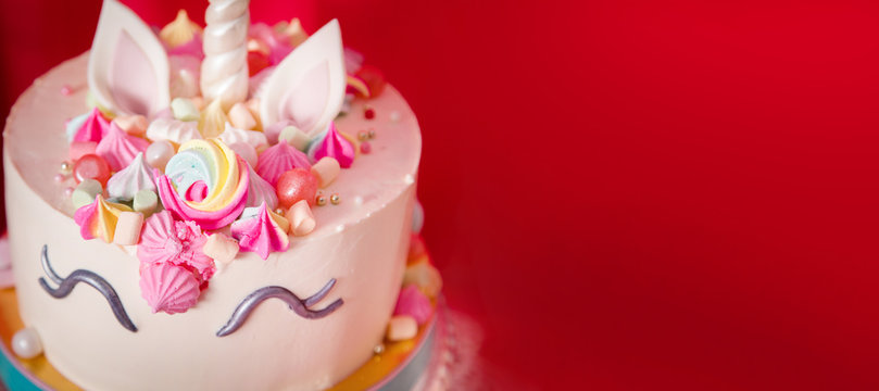 Sweet table and big unicorn cake for baby girl first birthday