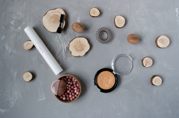  Makeup set on a gray background among the round wood