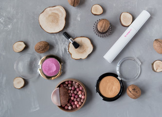  Makeup set on a gray background among the round wood
