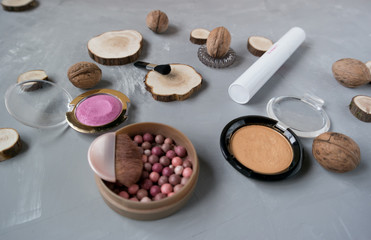  Makeup set on a gray background among the round wood