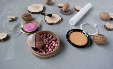  Makeup set on a gray background among the round wood