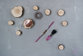 pink makeup brushes on gray background
