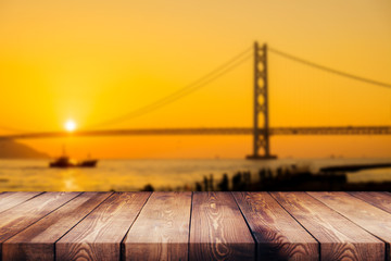 wood table top on blur background of bridge and river - can be used for display or montage your products