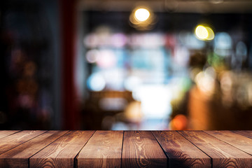 wood table on blur cafe, coffee shop, bar, background - can used for display or montage your products